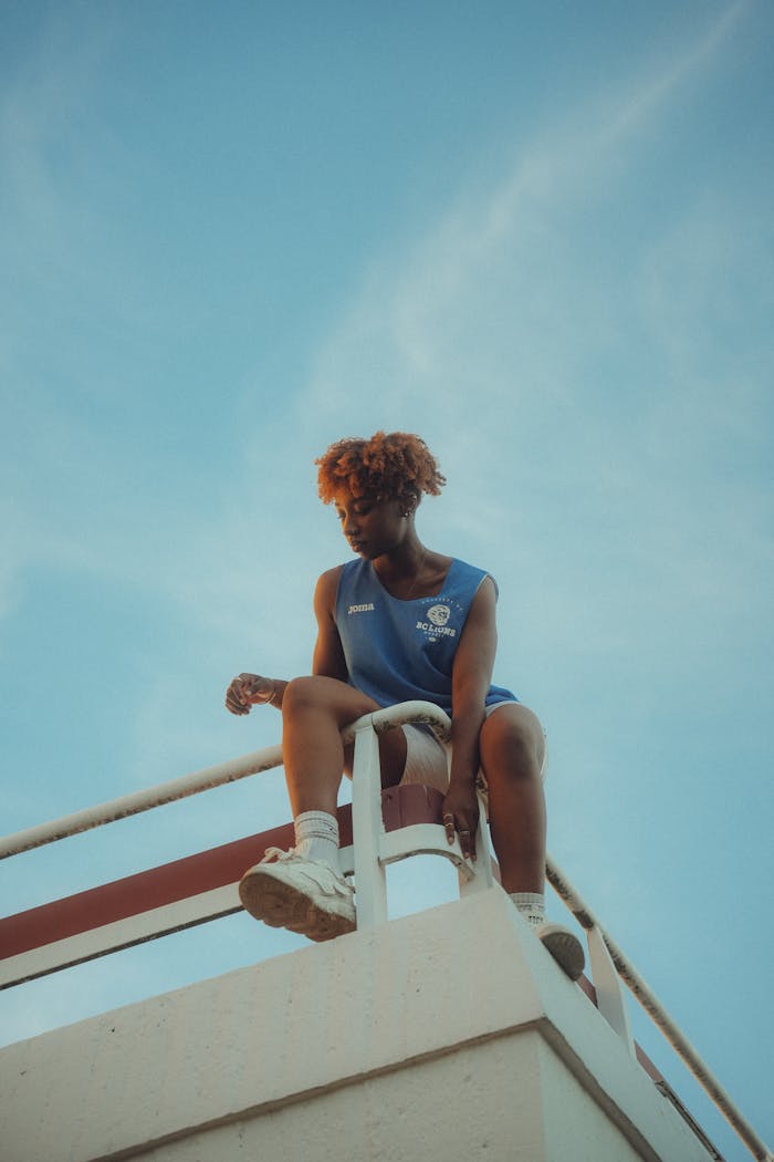 Woman in a Blue Tank Top Looking Down